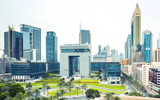 A panoramic view of a residential building in International City Dubai on a bright, sunny day with a clear blue sky.