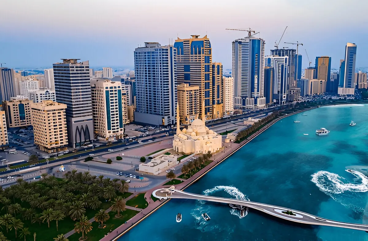 A view of Al Nahda, Sharjah, showcasing its proximity to Dubai, with modern buildings and a vibrant street scene.